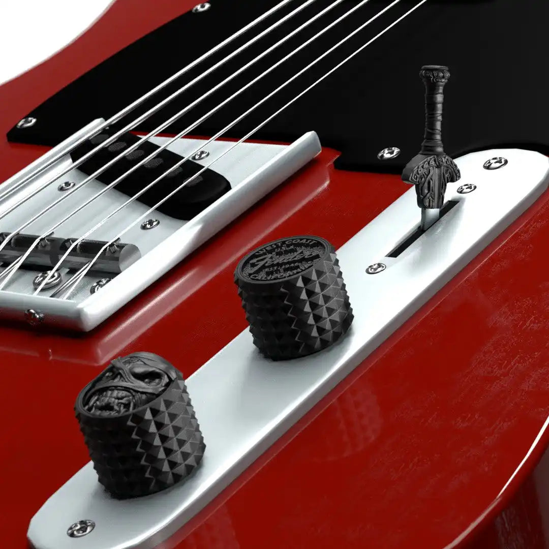 Red bass guitar with custom volume and tone knobs.