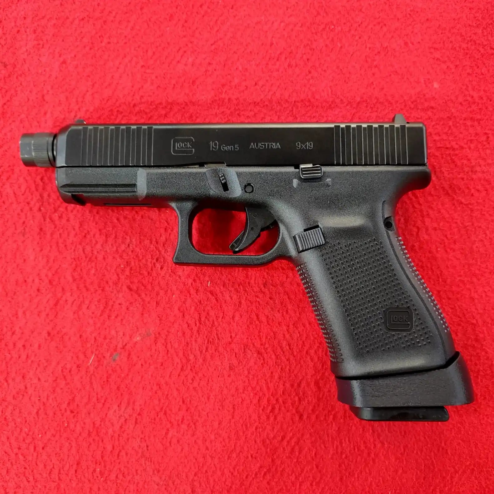 A black Glock 19 Gen 5 9x19 pistol.