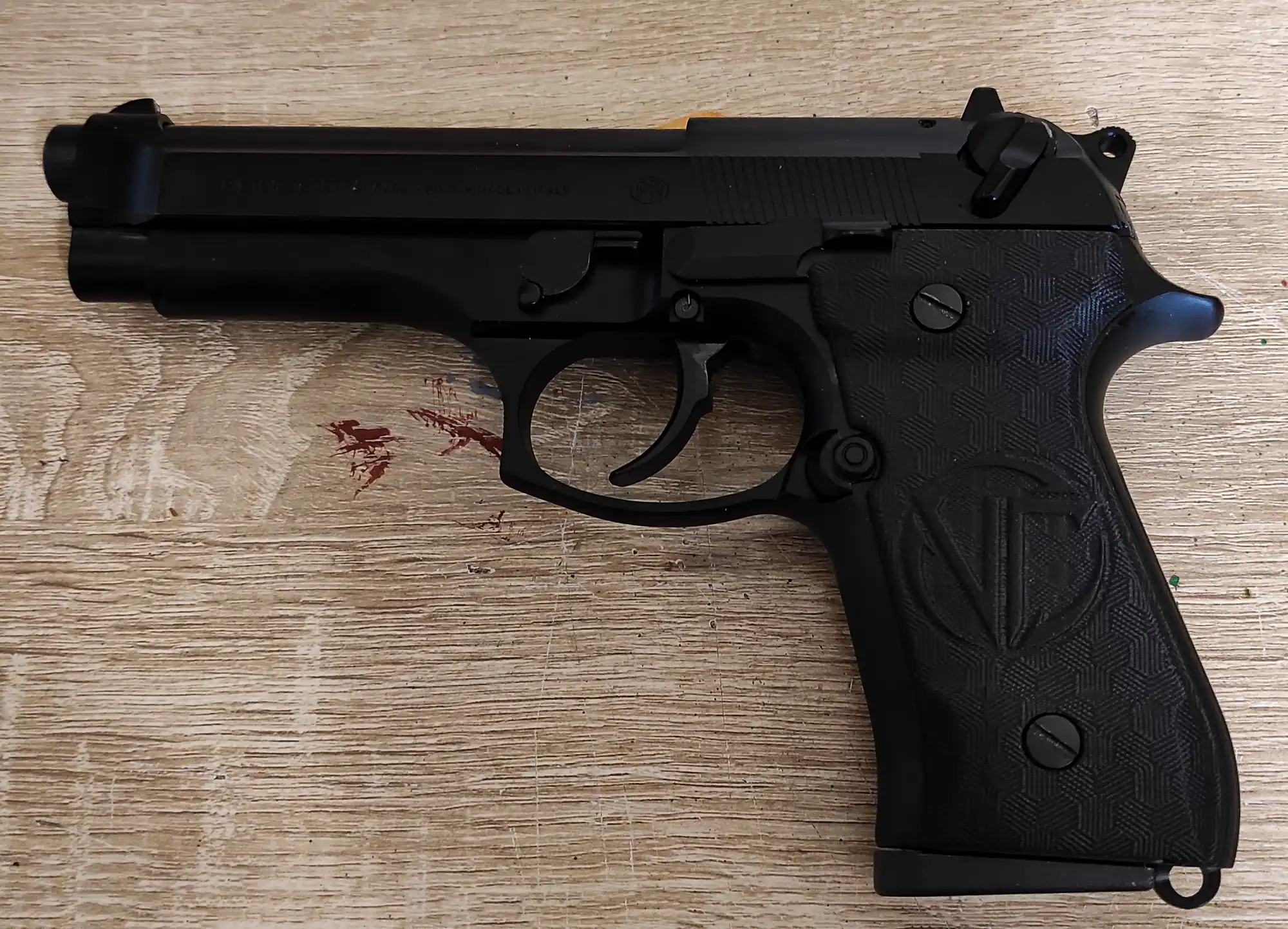 A black semi-automatic pistol with textured grips.